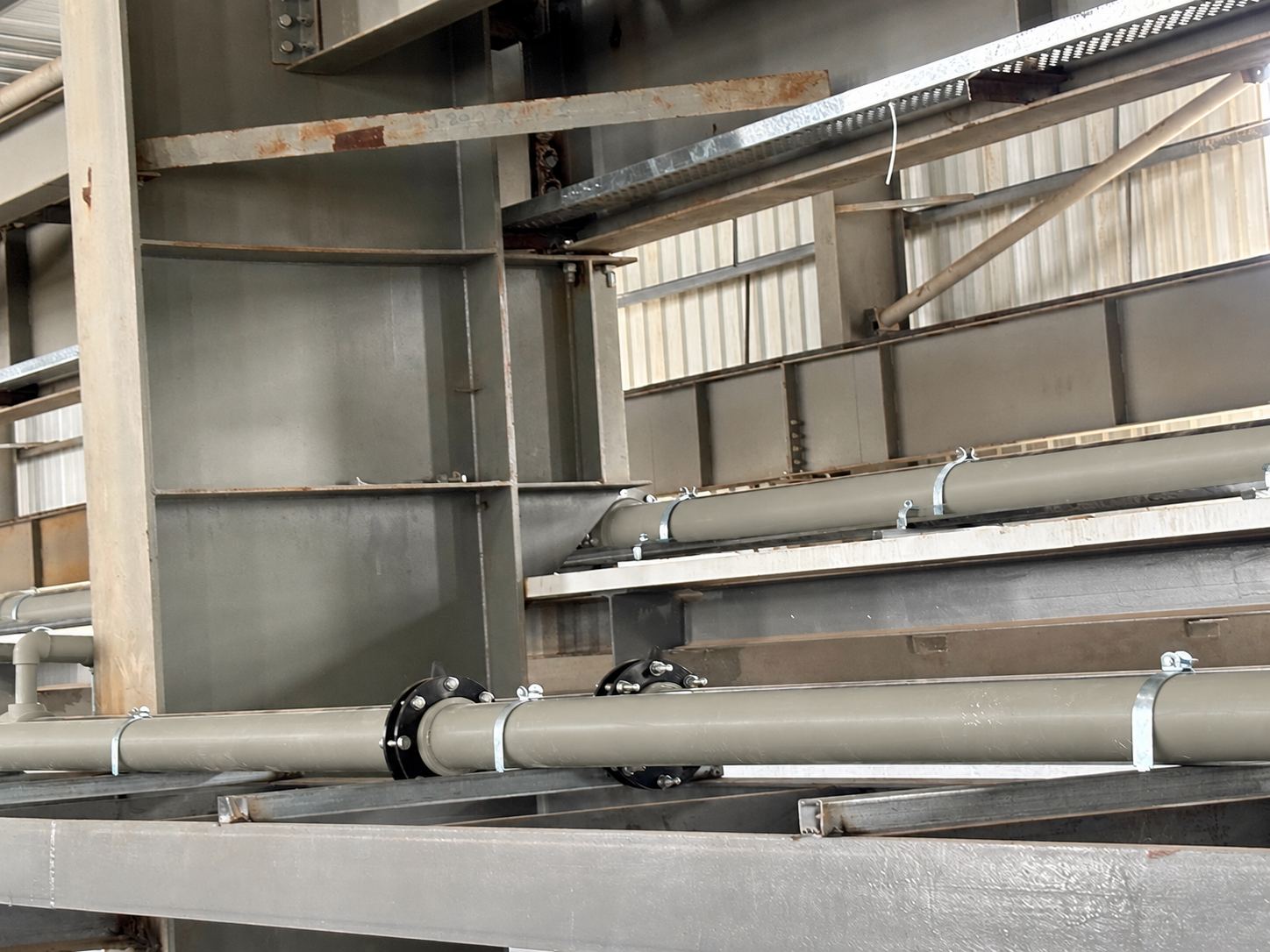 Grey PP-H chemical lines on a pipe rack